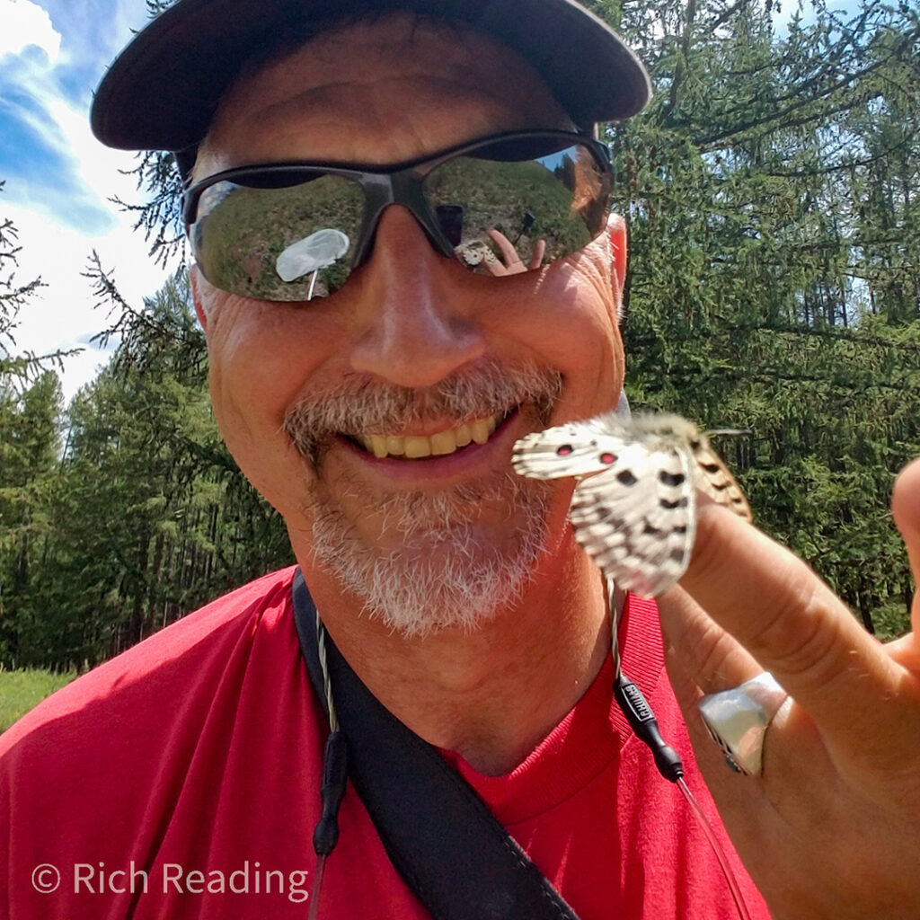 Rich holding a butterfly on his finger