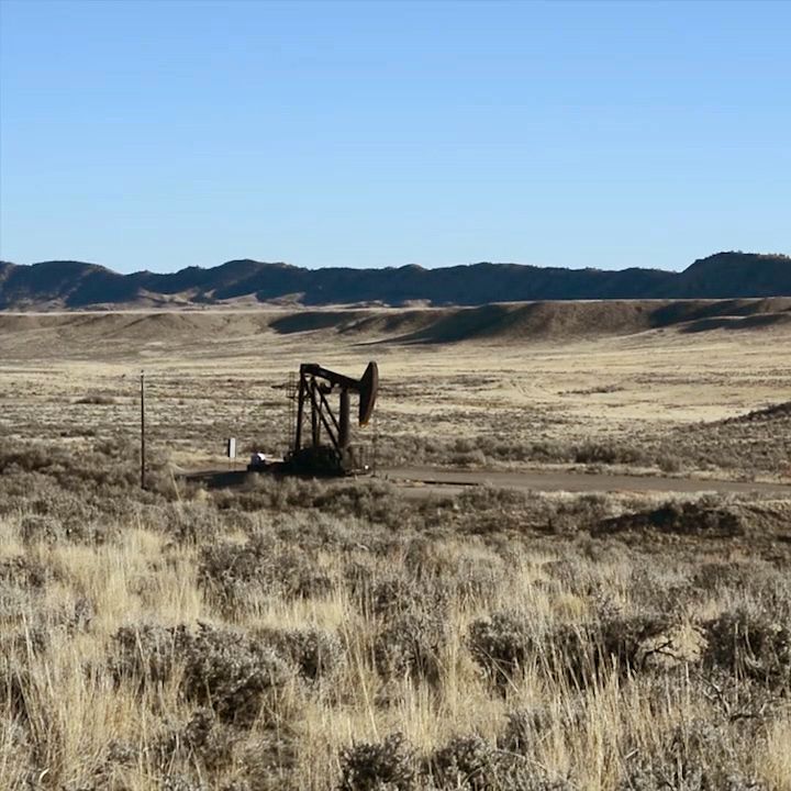 Oil derrick surrounded by sage brush