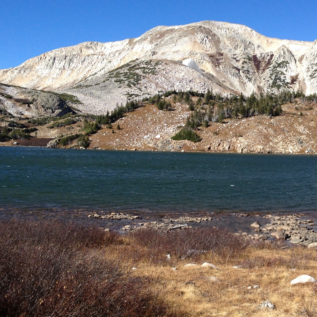 High mountain lake with snowcapped peaks in the background.
